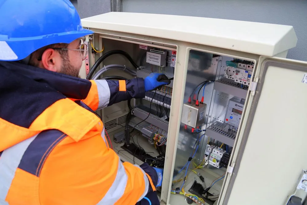 Electrician carrying out work on an electrical distribution panel