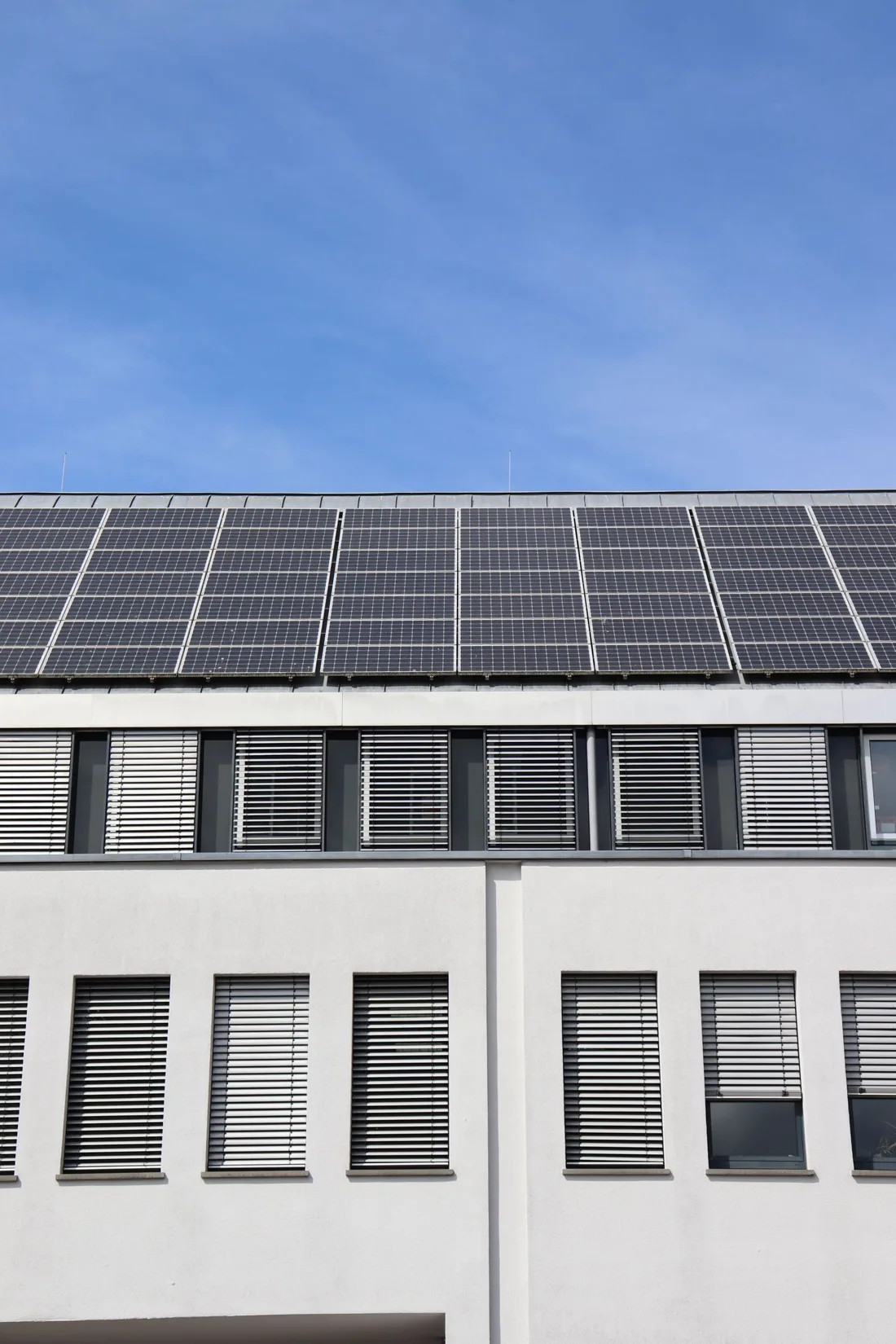 Solar panels integrated into a building roof in daylight